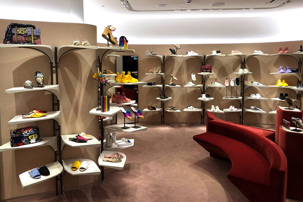 Interior of a shoe shop retail space, with cast jesmonite shelves, the masters of which were created using machined engineered wood